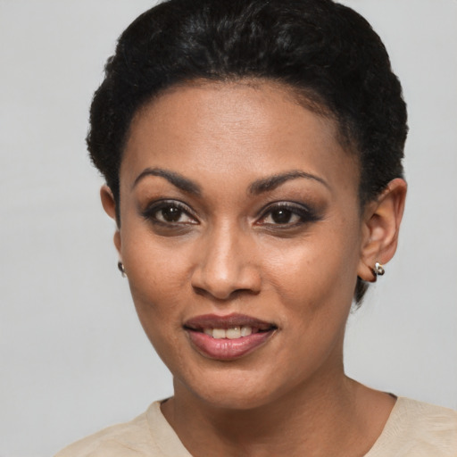 Joyful black young-adult female with short  brown hair and brown eyes