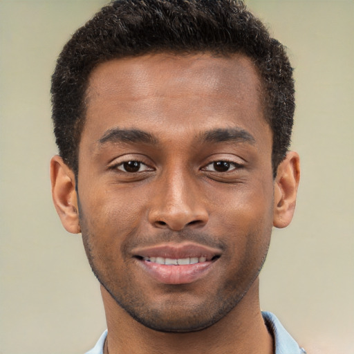 Joyful black young-adult male with short  brown hair and brown eyes