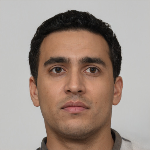 Neutral latino young-adult male with short  black hair and brown eyes
