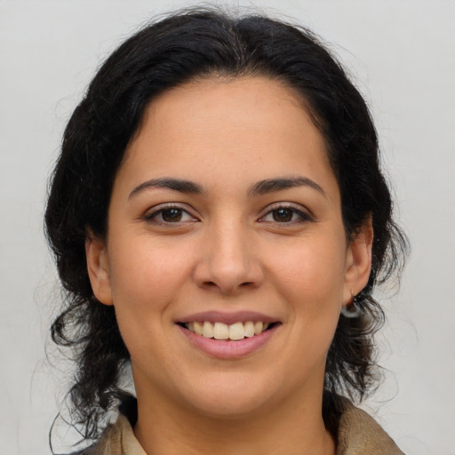 Joyful latino young-adult female with medium  brown hair and brown eyes