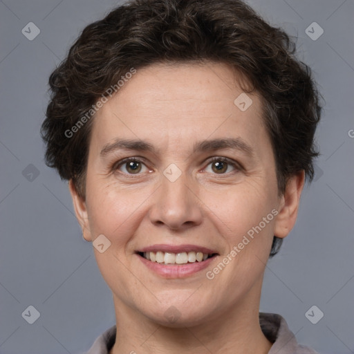 Joyful white adult female with short  brown hair and brown eyes