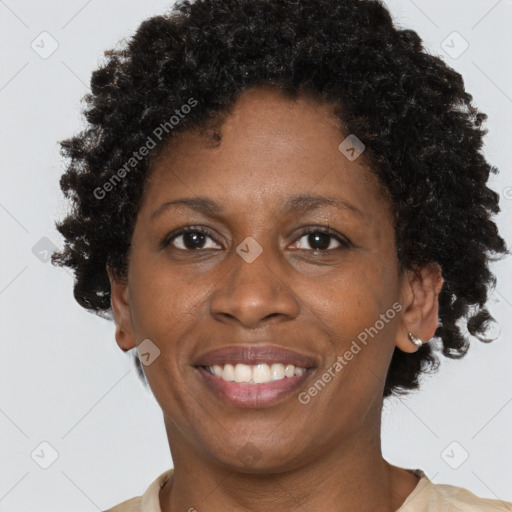 Joyful black adult female with short  brown hair and brown eyes