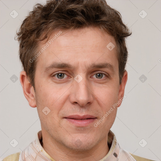 Joyful white adult male with short  brown hair and grey eyes