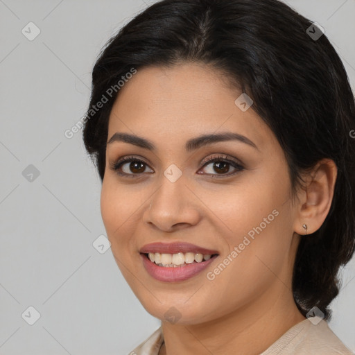 Joyful latino young-adult female with medium  brown hair and brown eyes