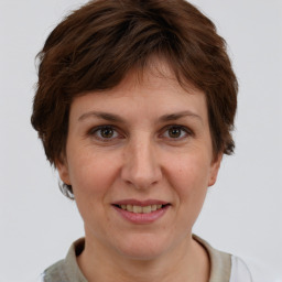 Joyful white adult female with short  brown hair and grey eyes