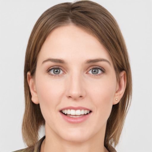 Joyful white young-adult female with medium  brown hair and grey eyes