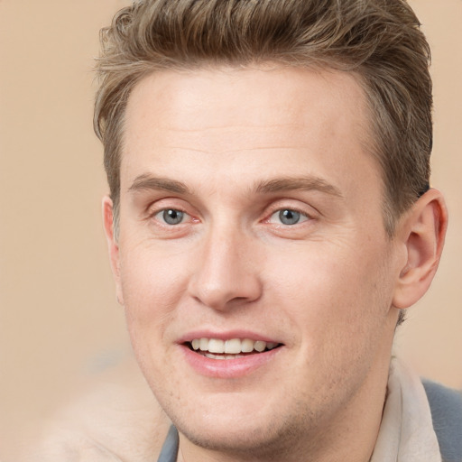 Joyful white adult male with short  brown hair and grey eyes