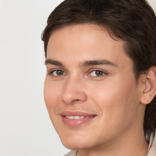 Joyful white young-adult male with medium  brown hair and brown eyes