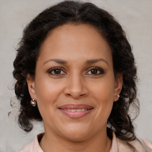Joyful black adult female with medium  brown hair and brown eyes