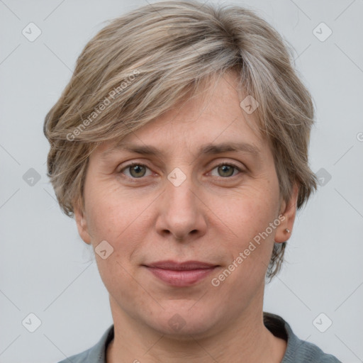 Joyful white adult female with medium  brown hair and grey eyes