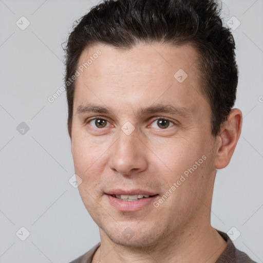 Joyful white adult male with short  brown hair and brown eyes