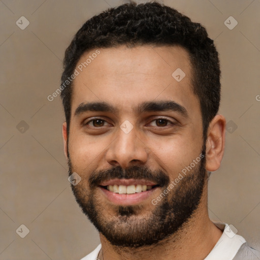 Joyful latino young-adult male with short  black hair and brown eyes