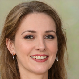 Joyful white young-adult female with long  brown hair and green eyes