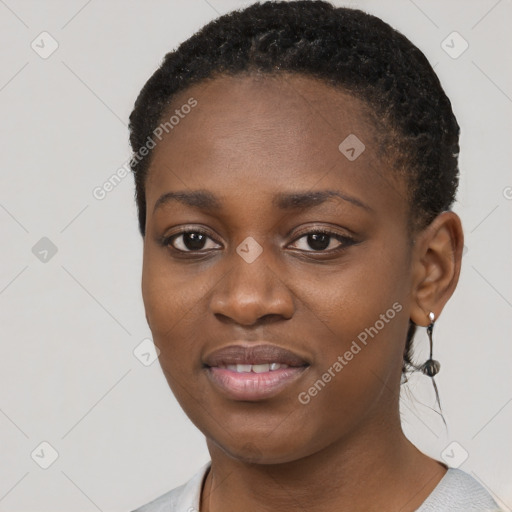 Joyful black young-adult female with short  black hair and brown eyes