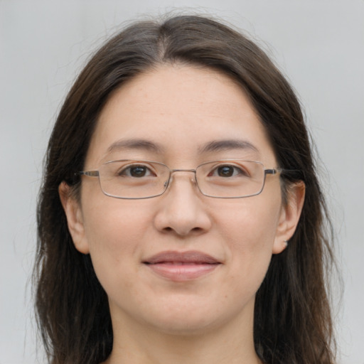 Joyful white adult female with long  brown hair and grey eyes