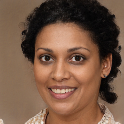 Joyful black young-adult female with medium  brown hair and brown eyes
