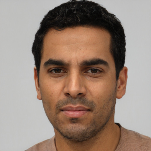 Neutral latino young-adult male with short  black hair and brown eyes