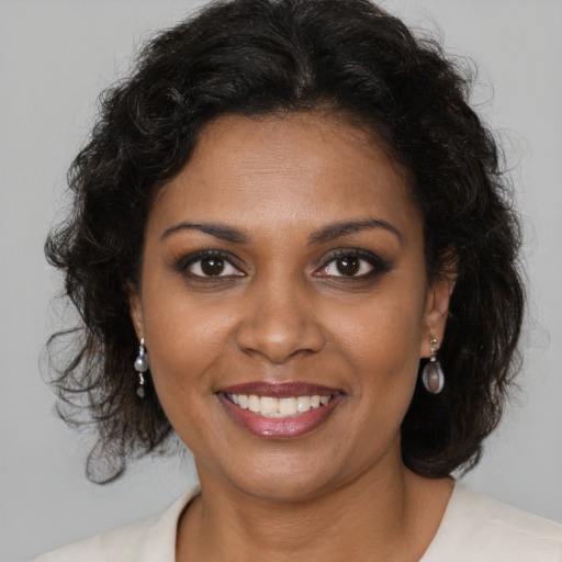 Joyful black young-adult female with medium  brown hair and brown eyes