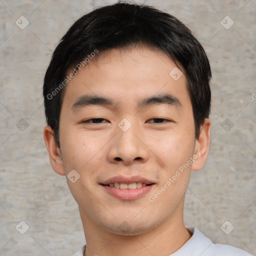 Joyful asian young-adult male with short  black hair and brown eyes