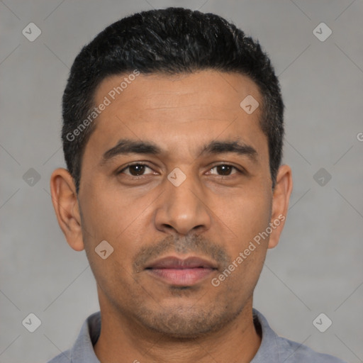 Joyful latino young-adult male with short  black hair and brown eyes