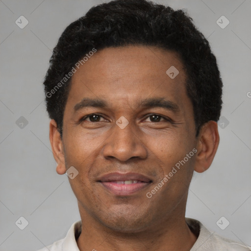 Joyful latino adult male with short  black hair and brown eyes