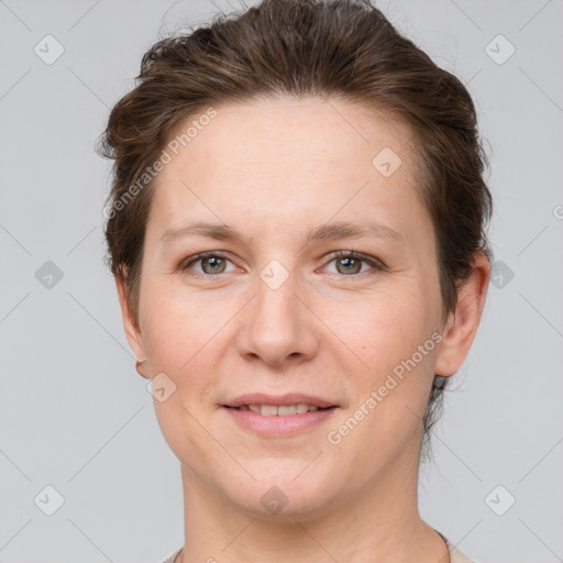 Joyful white adult female with short  brown hair and grey eyes