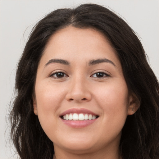 Joyful white young-adult female with long  brown hair and brown eyes