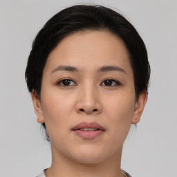 Joyful asian young-adult female with short  black hair and brown eyes