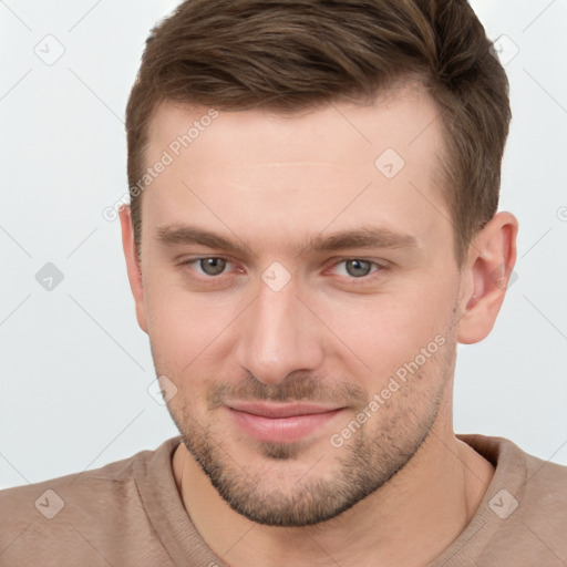 Joyful white young-adult male with short  brown hair and grey eyes