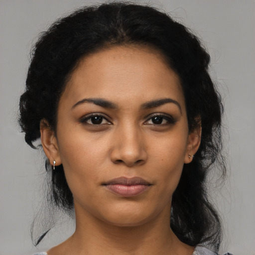 Joyful latino young-adult female with medium  black hair and brown eyes