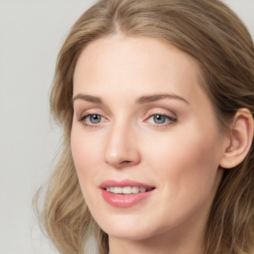 Joyful white young-adult female with long  brown hair and green eyes