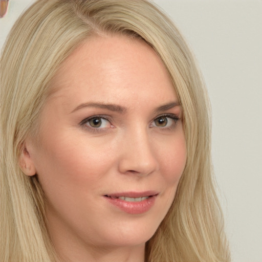 Joyful white young-adult female with long  blond hair and brown eyes