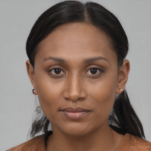 Joyful black young-adult female with short  brown hair and brown eyes
