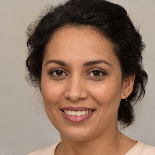 Joyful white adult female with medium  brown hair and brown eyes