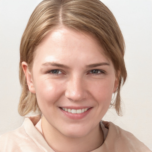 Joyful white young-adult female with medium  brown hair and blue eyes