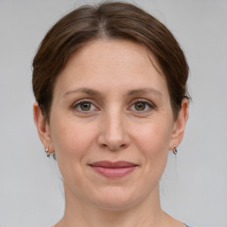 Joyful white adult female with medium  brown hair and grey eyes