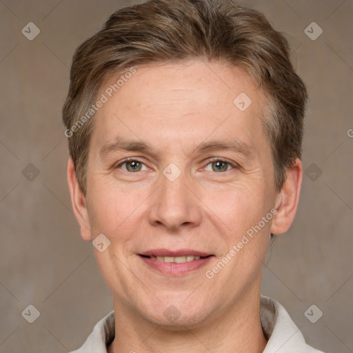 Joyful white adult male with short  brown hair and grey eyes