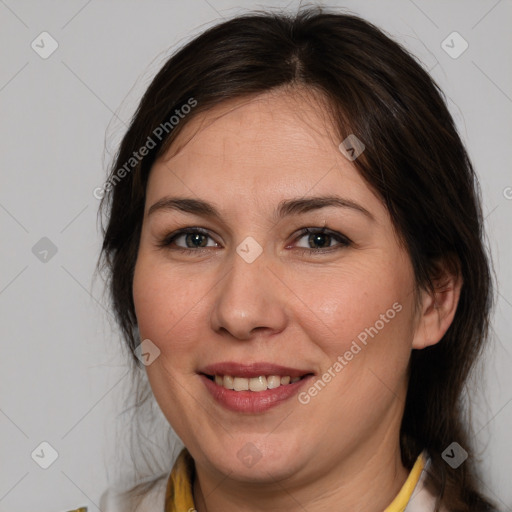 Joyful white adult female with medium  brown hair and brown eyes