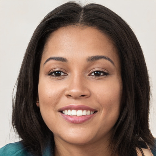 Joyful white young-adult female with long  brown hair and brown eyes