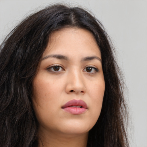 Neutral latino young-adult female with long  brown hair and brown eyes