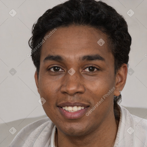 Joyful black young-adult male with short  black hair and brown eyes