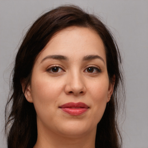 Joyful white young-adult female with long  brown hair and brown eyes