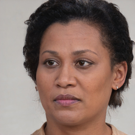 Joyful black adult female with short  brown hair and brown eyes
