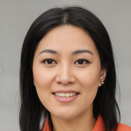 Joyful asian young-adult female with medium  brown hair and brown eyes