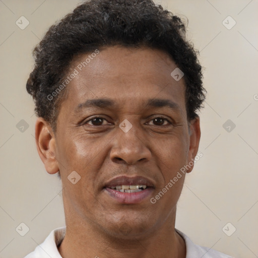 Joyful black young-adult male with short  brown hair and brown eyes