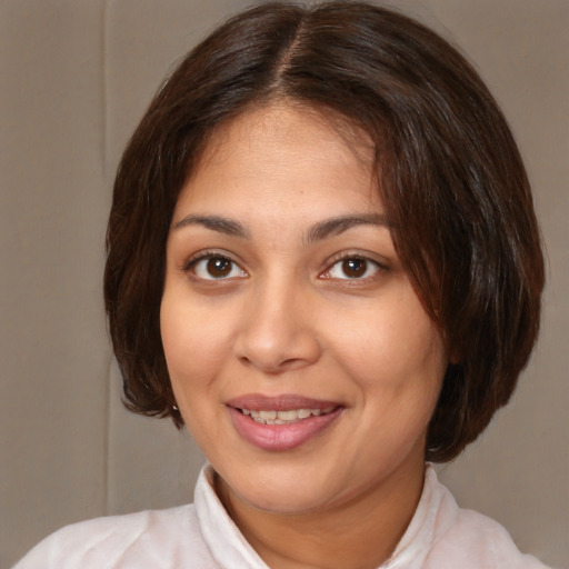 Joyful white young-adult female with medium  brown hair and brown eyes