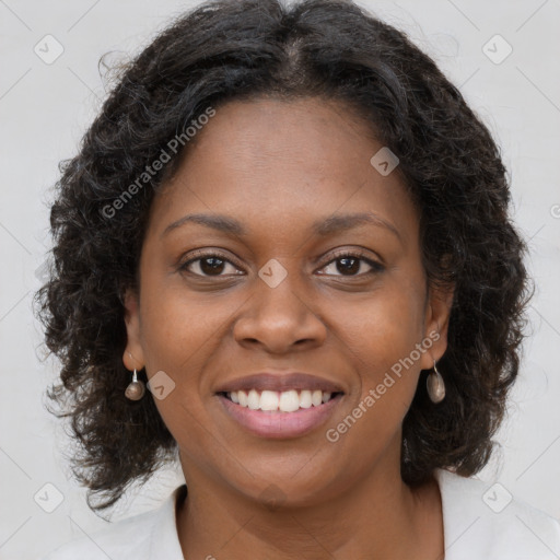 Joyful black young-adult female with long  brown hair and brown eyes