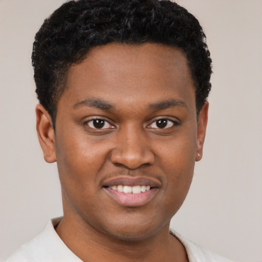Joyful black young-adult male with short  brown hair and brown eyes