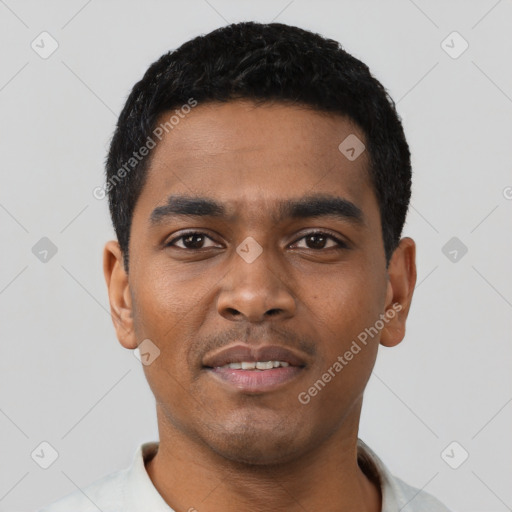 Joyful black young-adult male with short  black hair and brown eyes