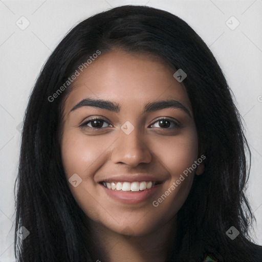 Joyful black young-adult female with long  black hair and brown eyes